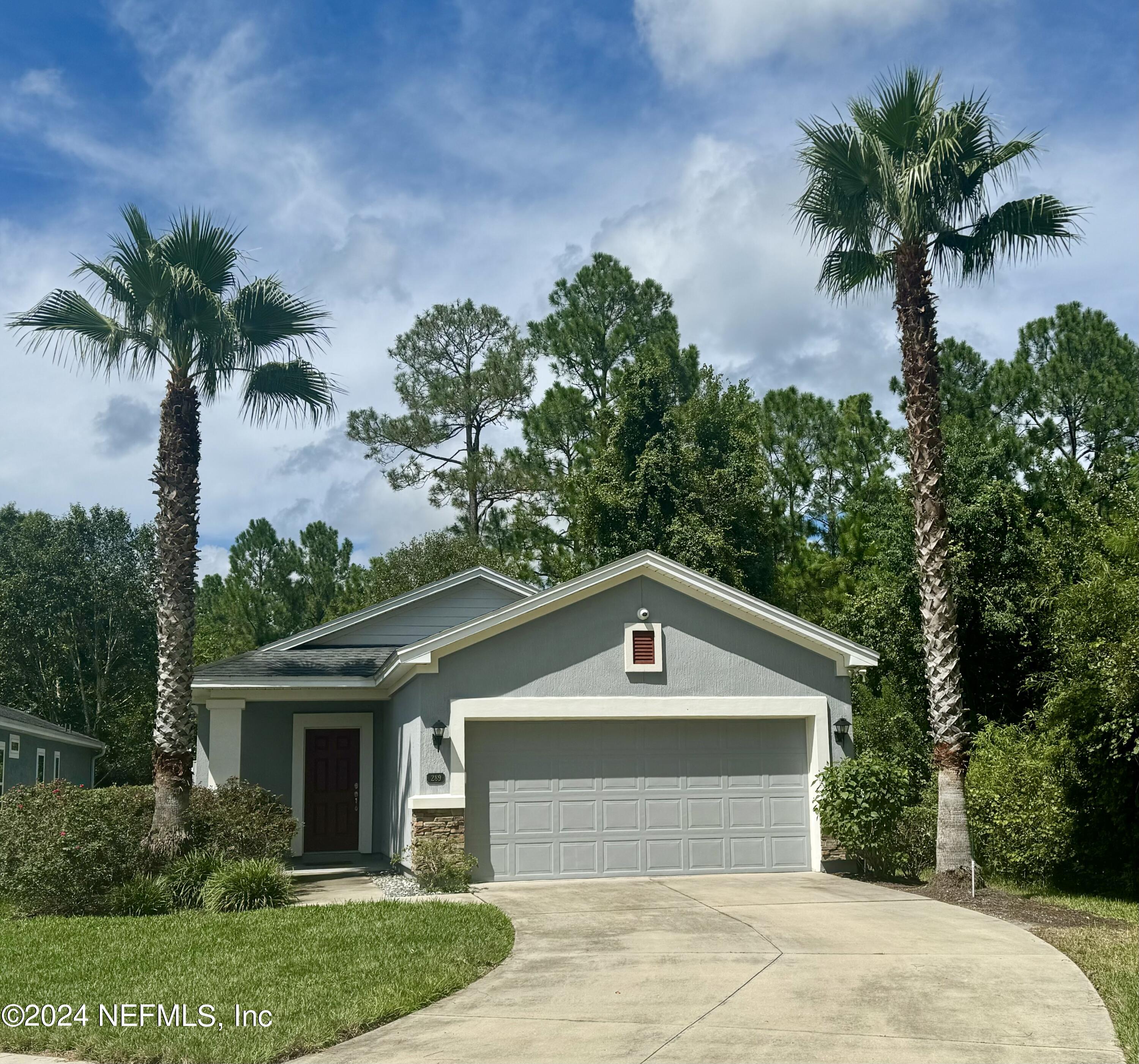 289 Spring Park Avenue Ponte Vedra, FL 32081 - Photo 1 of 19 a front view of a house with a yard and garage