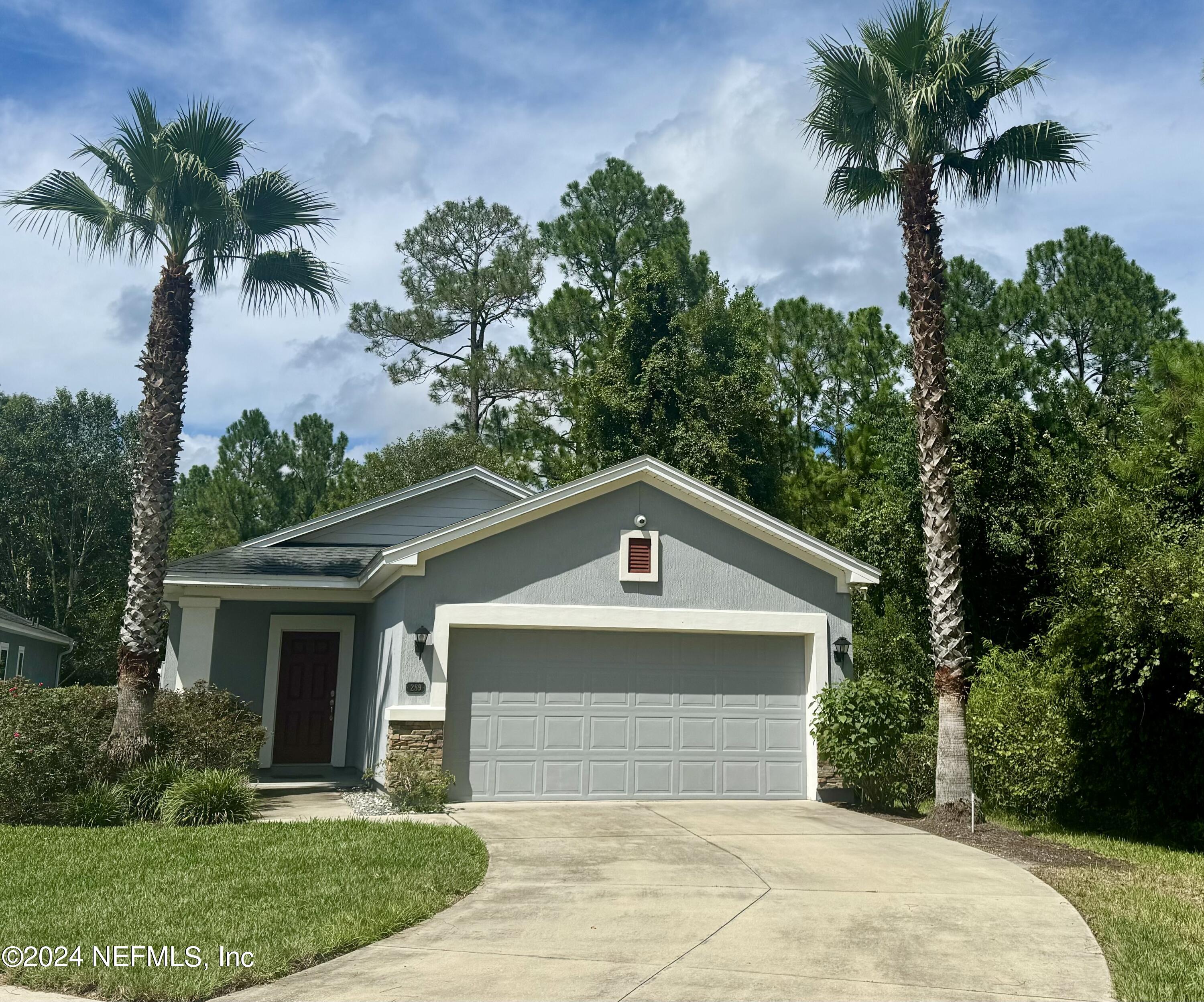 289 Spring Park Avenue Ponte Vedra, FL 32081 - Photo 18 of 19 a front view of a house with a yard and garage