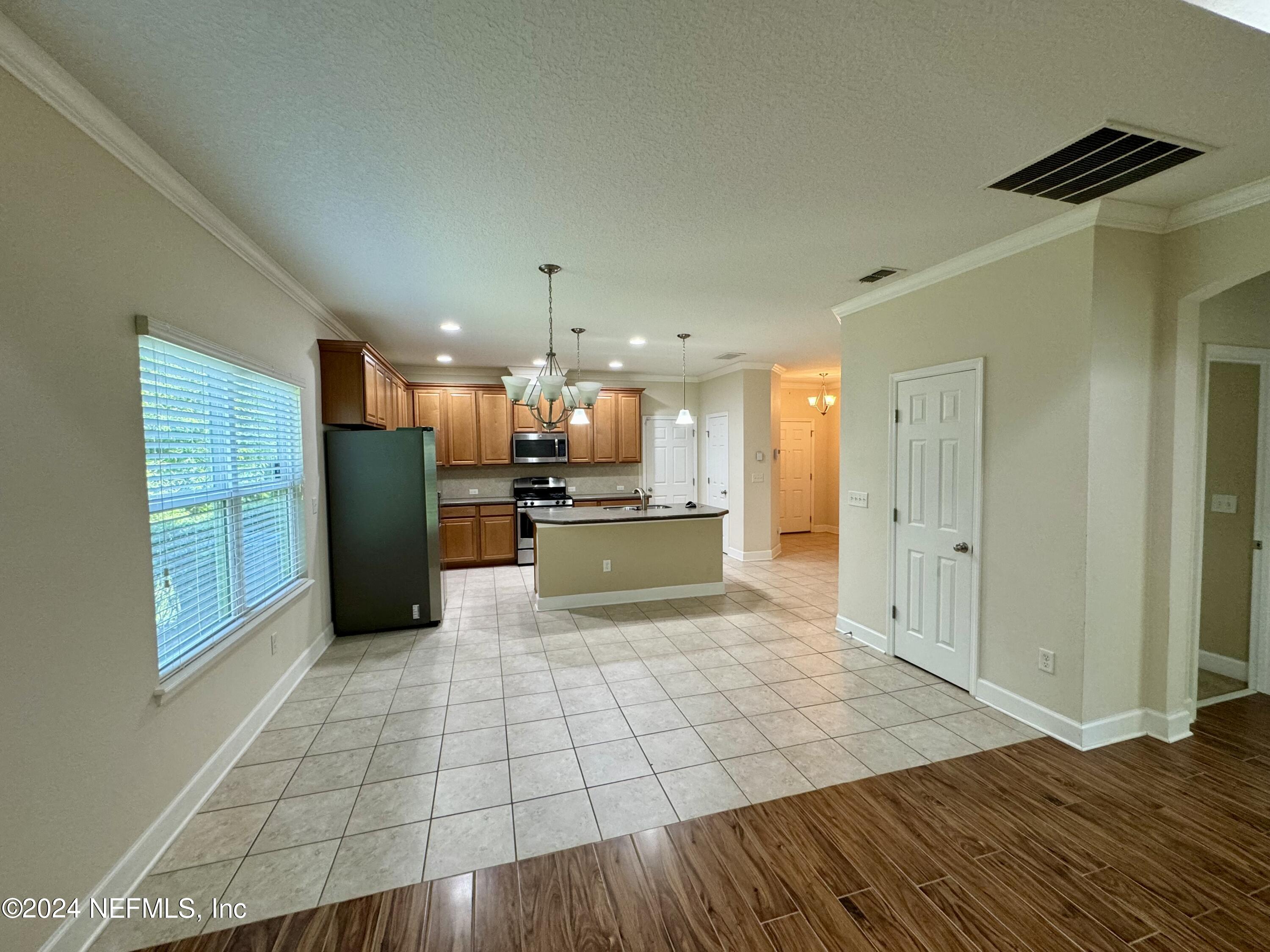 289 Spring Park Avenue Ponte Vedra, FL 32081 - Photo 4 of 19 a view of kitchen view with wooden floor and a refrigerator