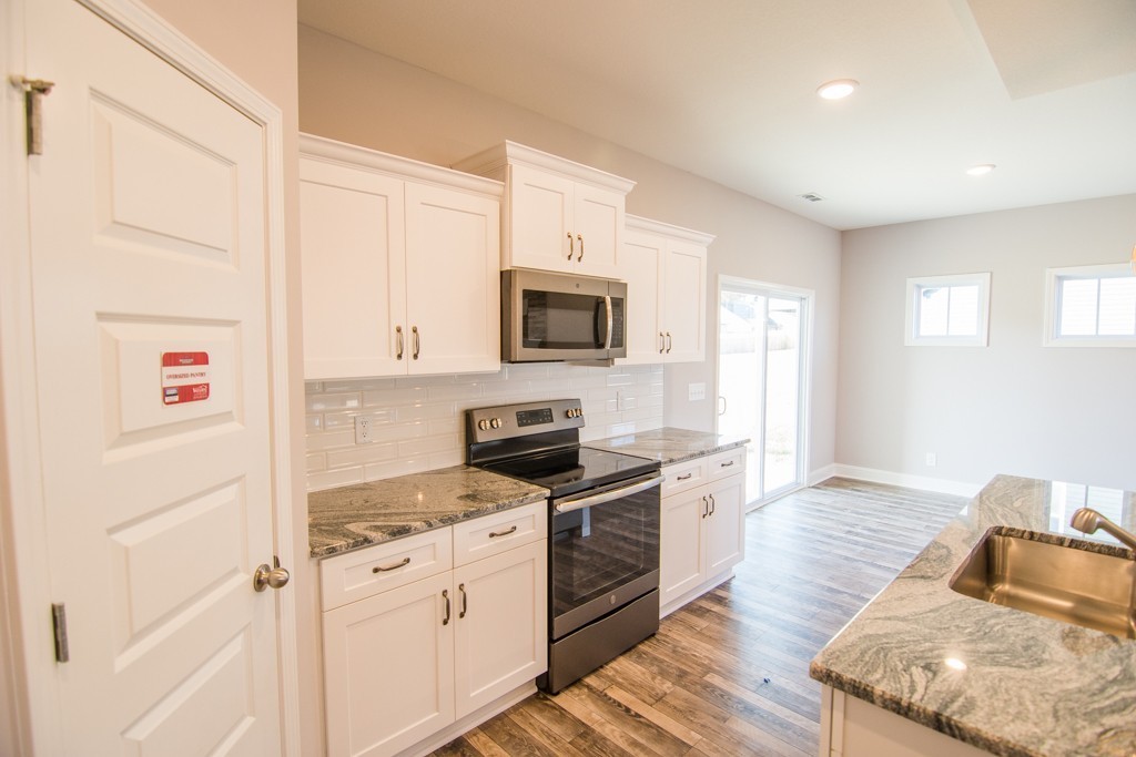 255 Mill Creek Road Clarksville, TN 37042 - Photo 10 of 10 a kitchen with granite countertop a stove top oven sink and cabinets
