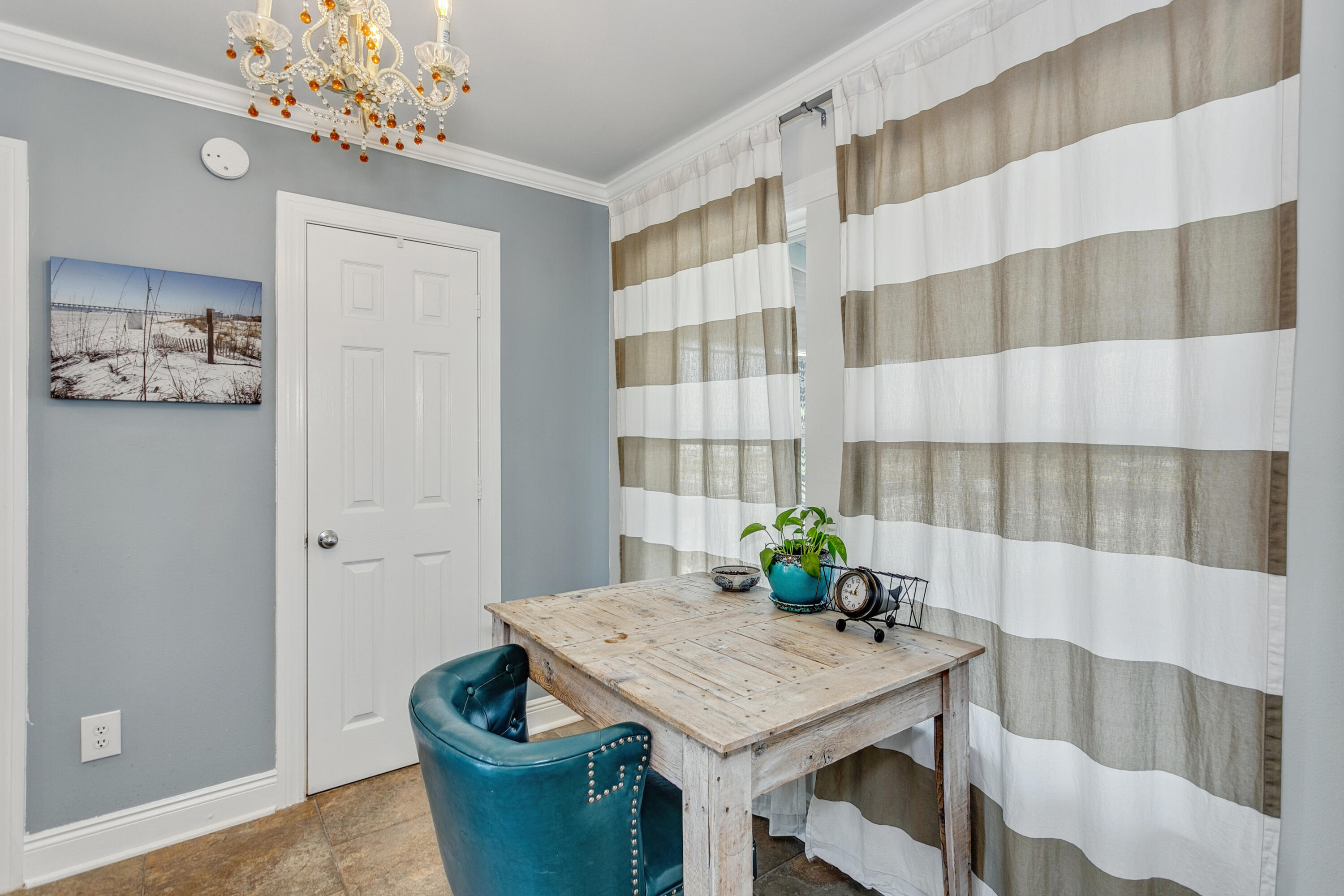 7905 White Sands Boulevard, Unit 2 Navarre, FL 32566 - Photo 17 of 51 a dining room with furniture and chandelier