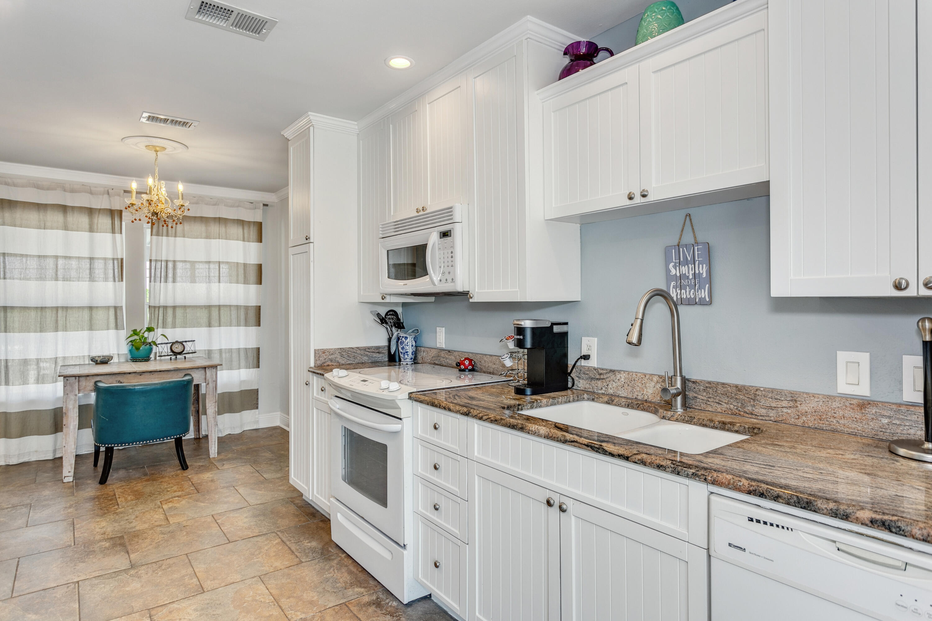 7905 White Sands Boulevard, Unit 2 Navarre, FL 32566 - Photo 20 of 51 a kitchen with a sink stove and cabinets