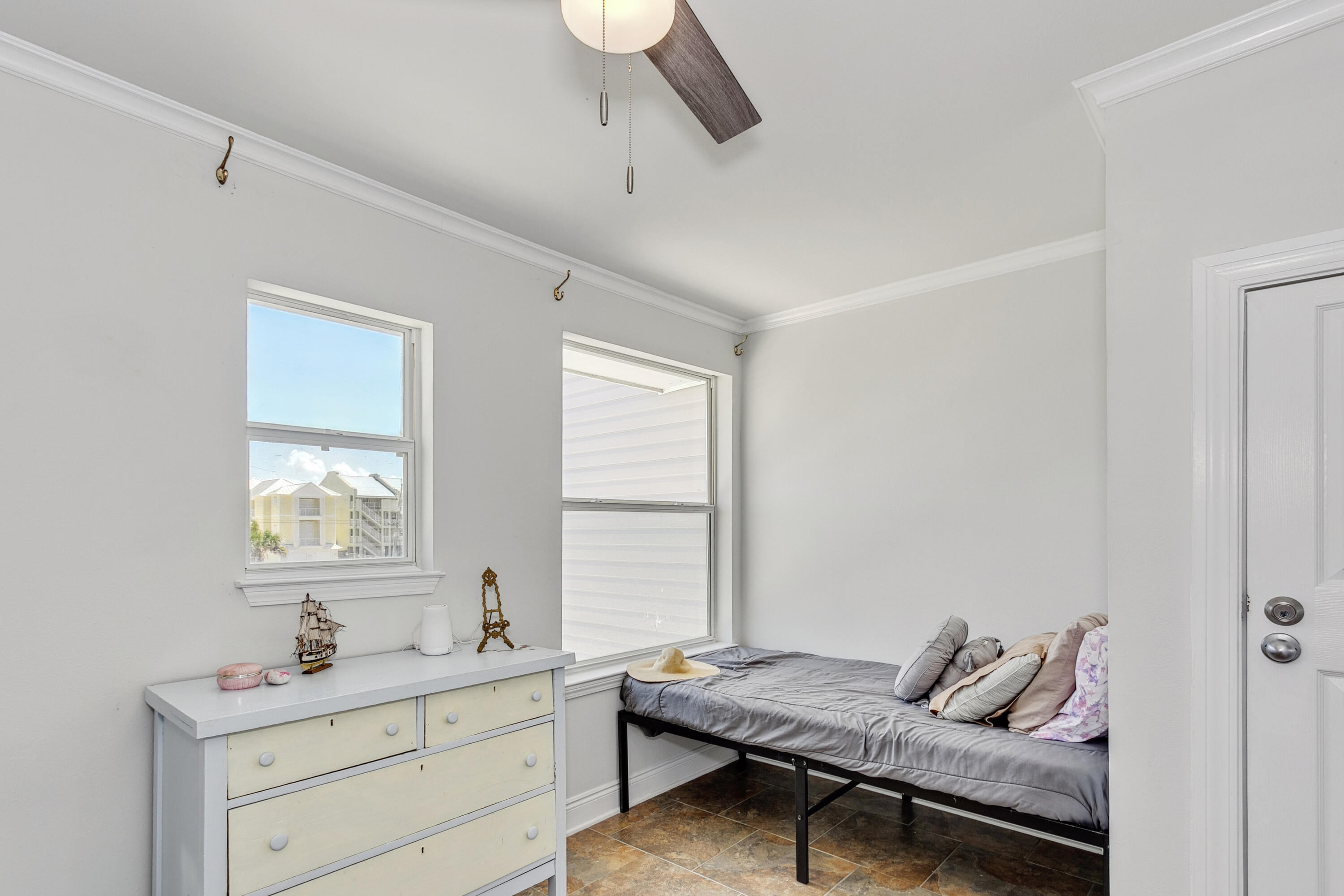 7905 White Sands Boulevard, Unit 2 Navarre, FL 32566 - Photo 26 of 51 a bedroom with a bed and a window