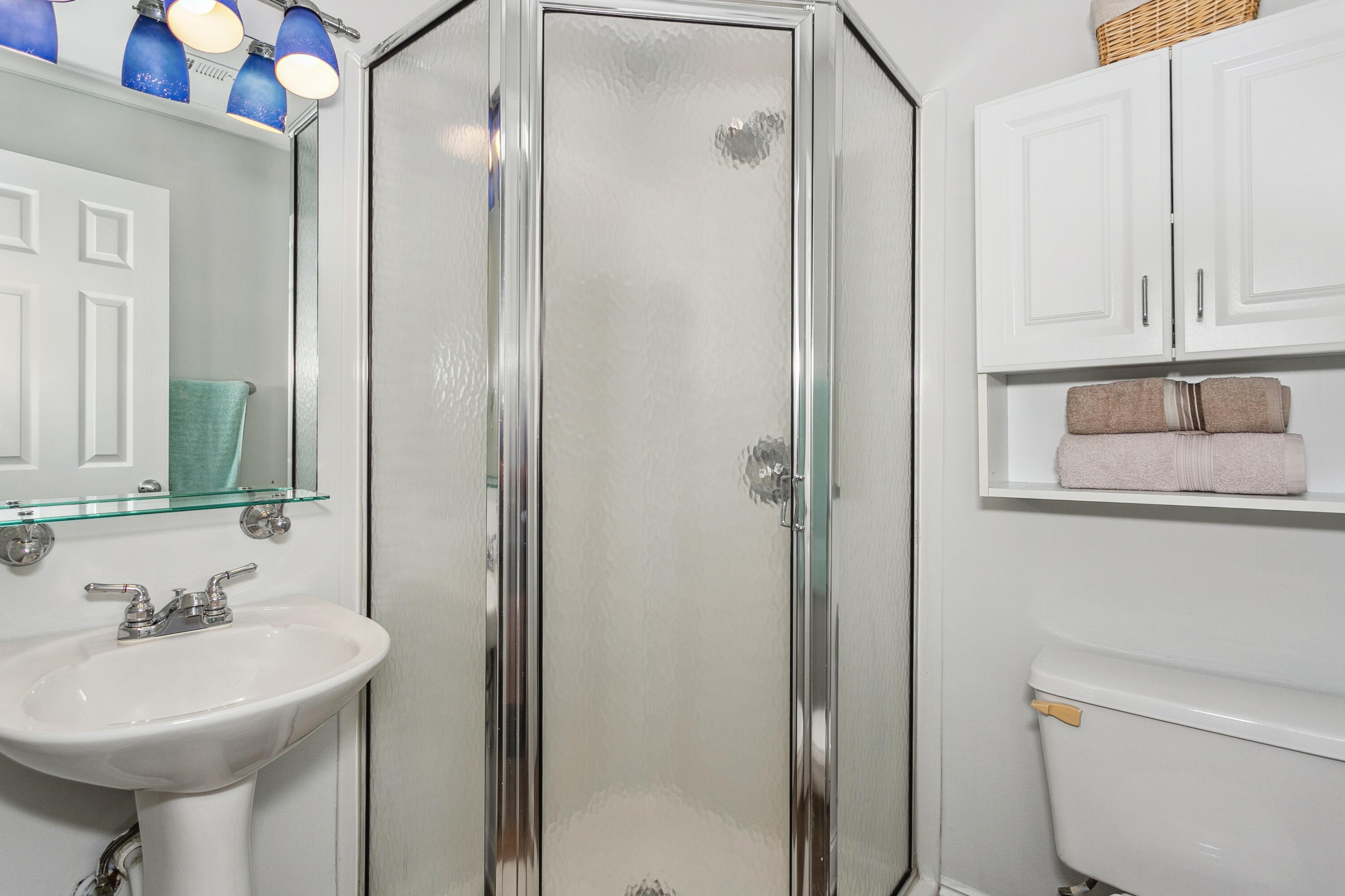 7905 White Sands Boulevard, Unit 2 Navarre, FL 32566 - Photo 27 of 51 a bathroom with a sink a toilet and a mirror