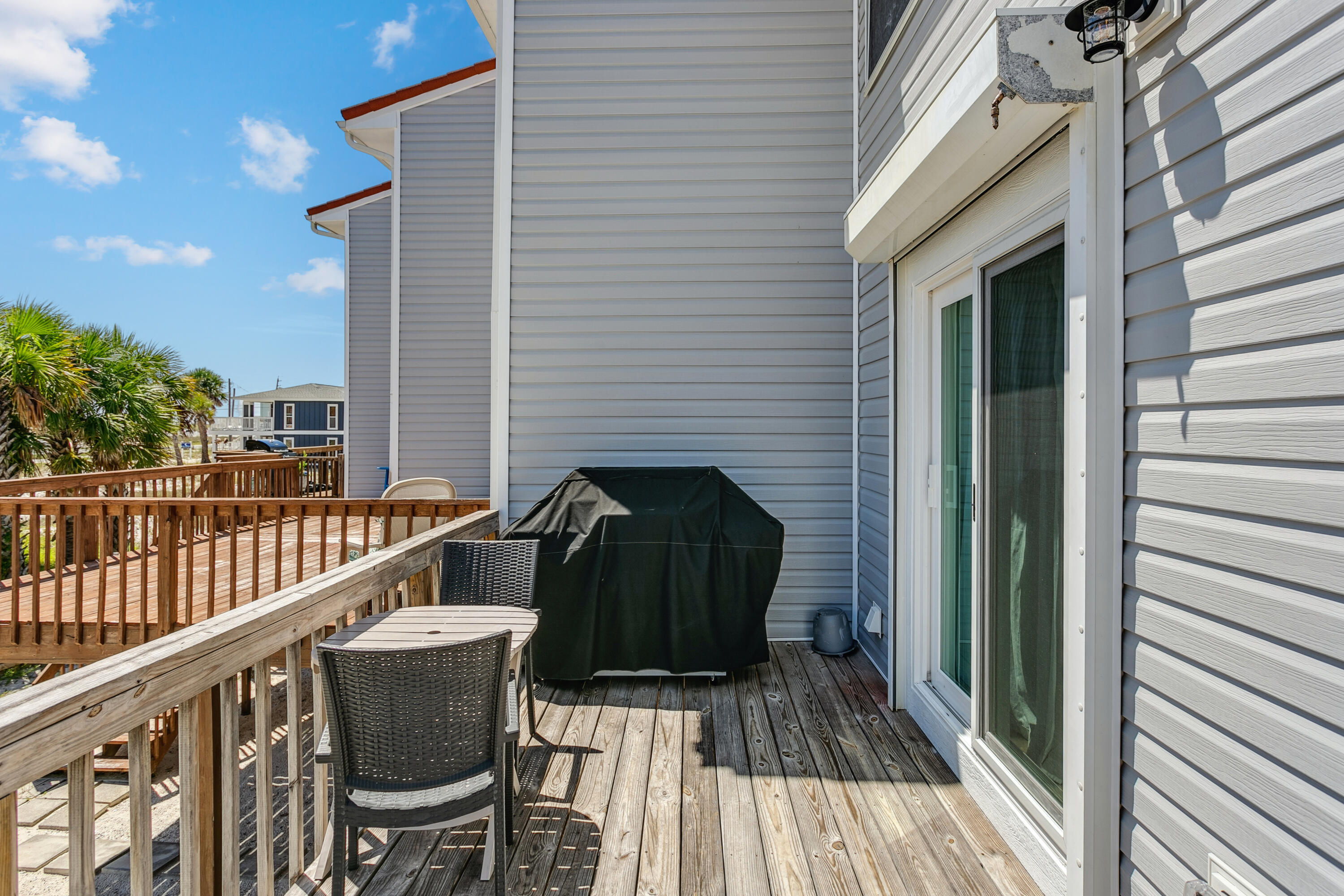 7905 White Sands Boulevard, Unit 2 Navarre, FL 32566 - Photo 30 of 51 a view of balcony with wooden floor and seating space