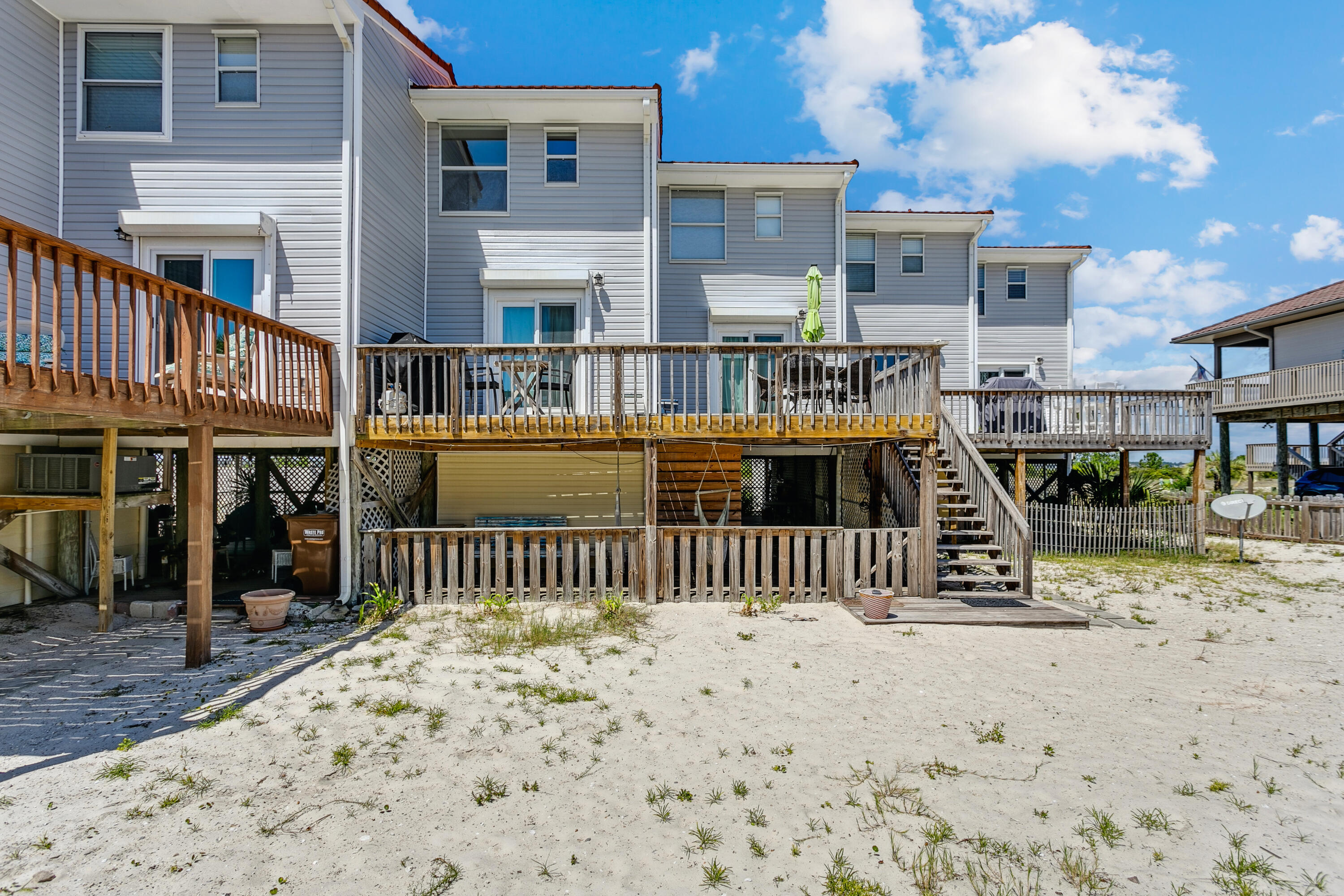7905 White Sands Boulevard, Unit 2 Navarre, FL 32566 - Photo 31 of 51 a view of a house with a wooden deck