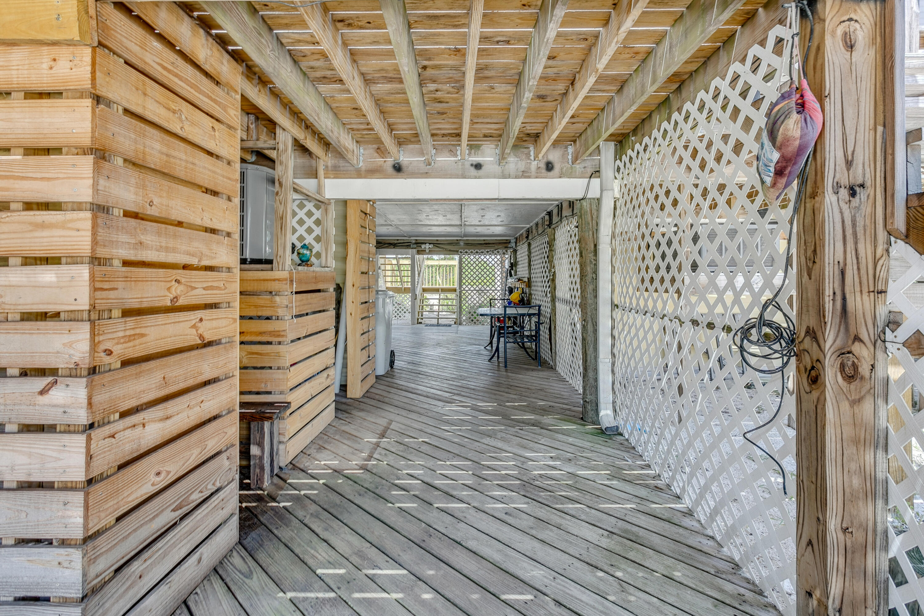 7905 White Sands Boulevard, Unit 2 Navarre, FL 32566 - Photo 33 of 51 a view of a patio door with wooden floor