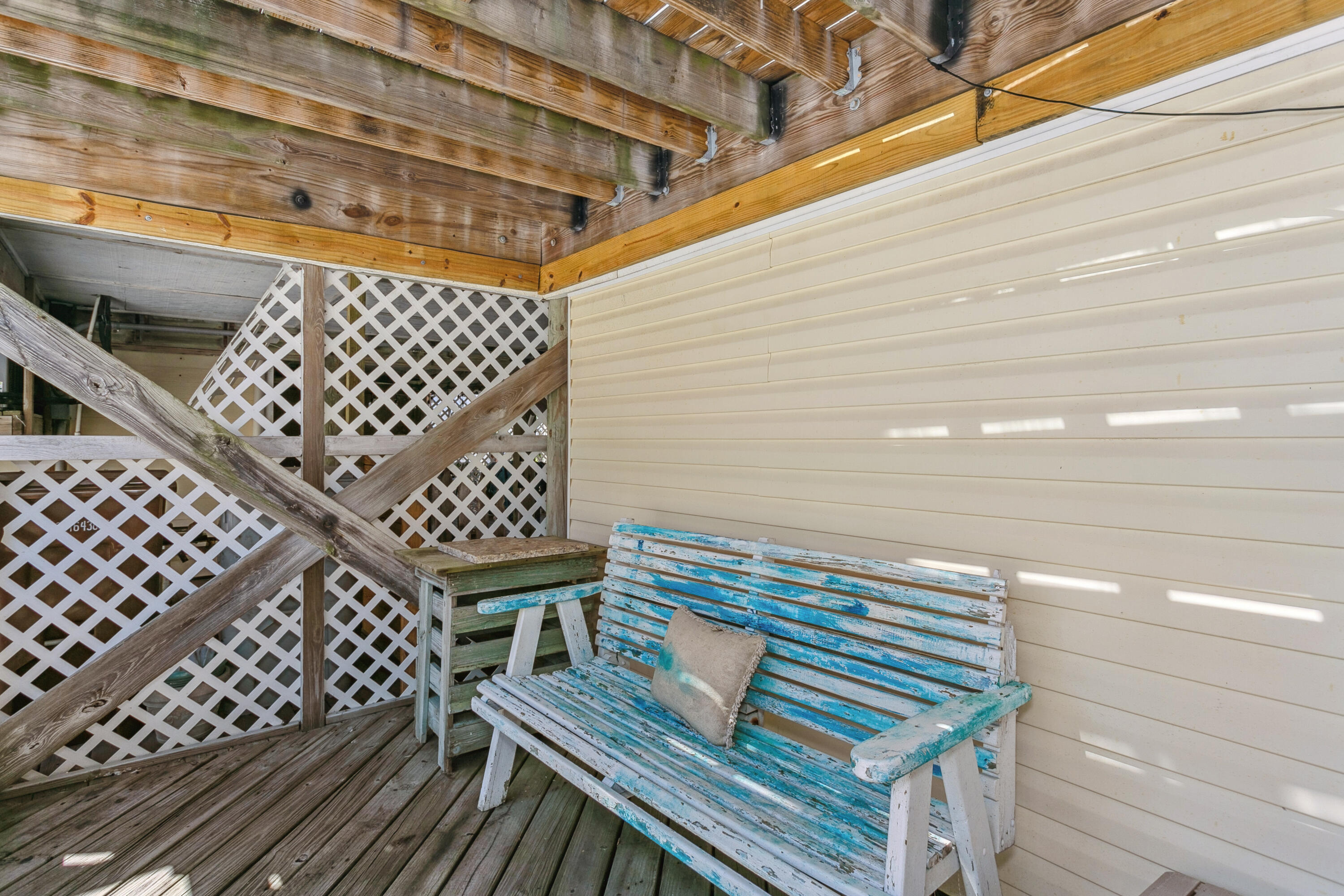 7905 White Sands Boulevard, Unit 2 Navarre, FL 32566 - Photo 37 of 51 a view of a balcony with wooden floor