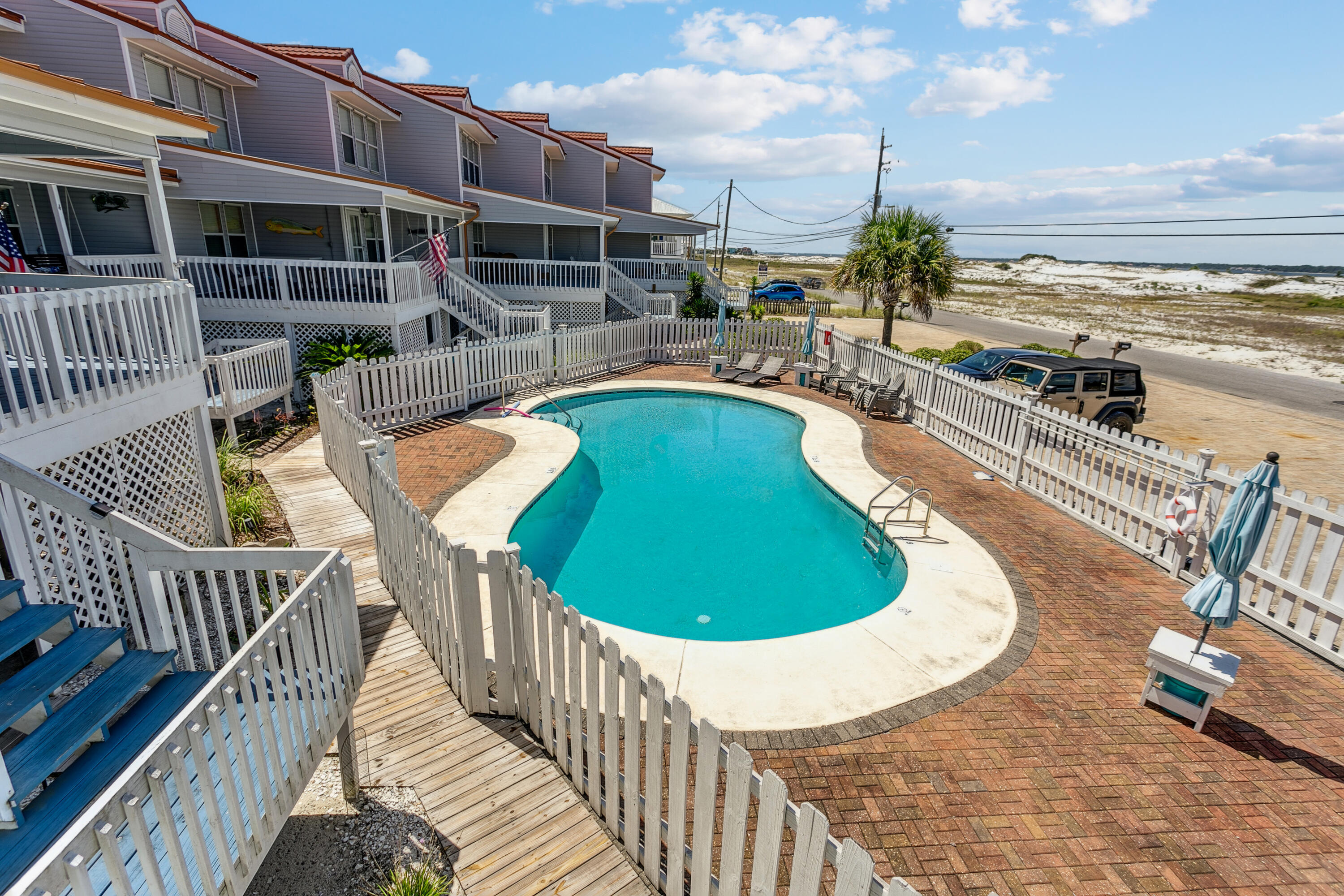 7905 White Sands Boulevard, Unit 2 Navarre, FL 32566 - Photo 38 of 51 a view of a swimming pool with lounge chair