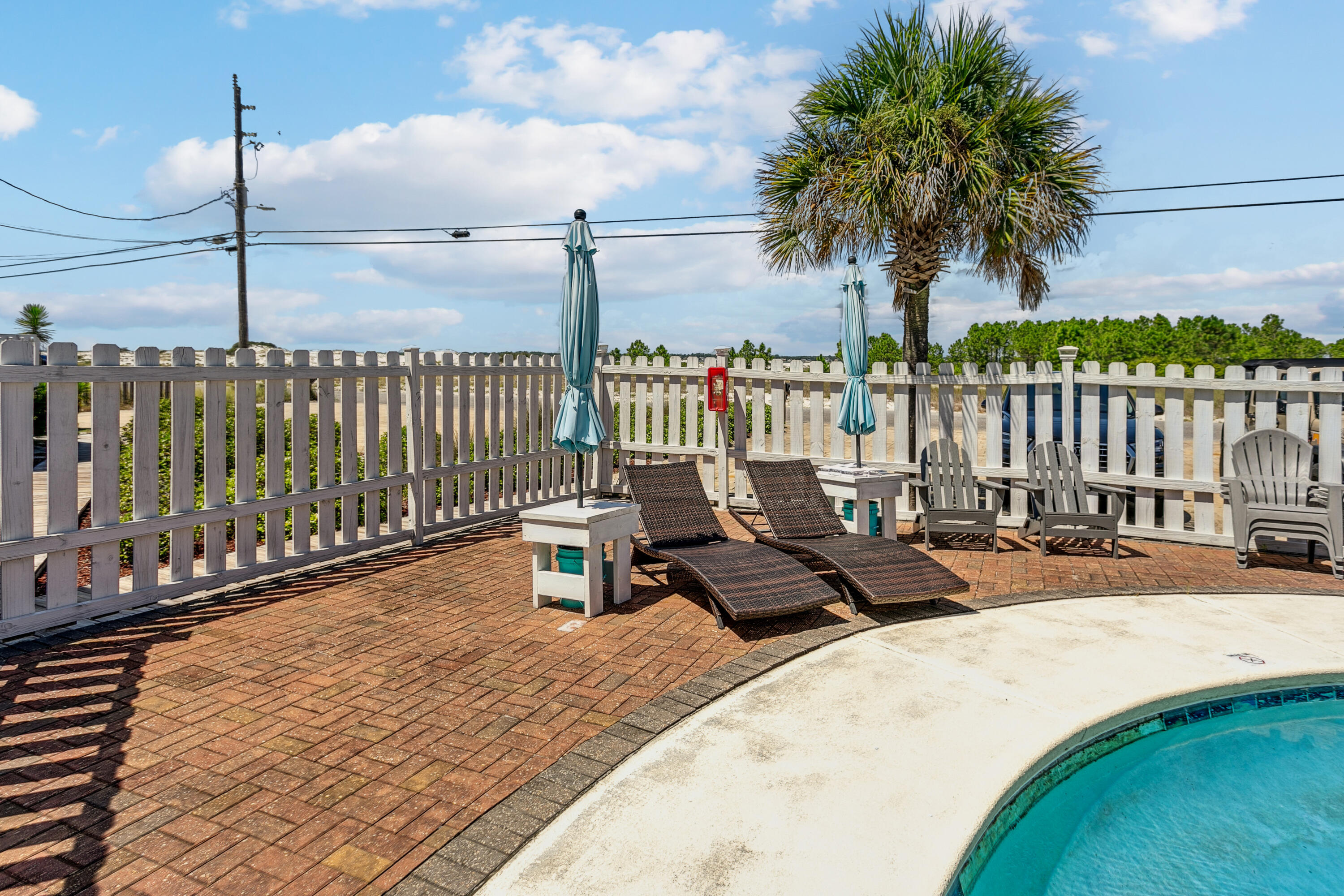 7905 White Sands Boulevard, Unit 2 Navarre, FL 32566 - Photo 39 of 51 a view of a terrace with chairs