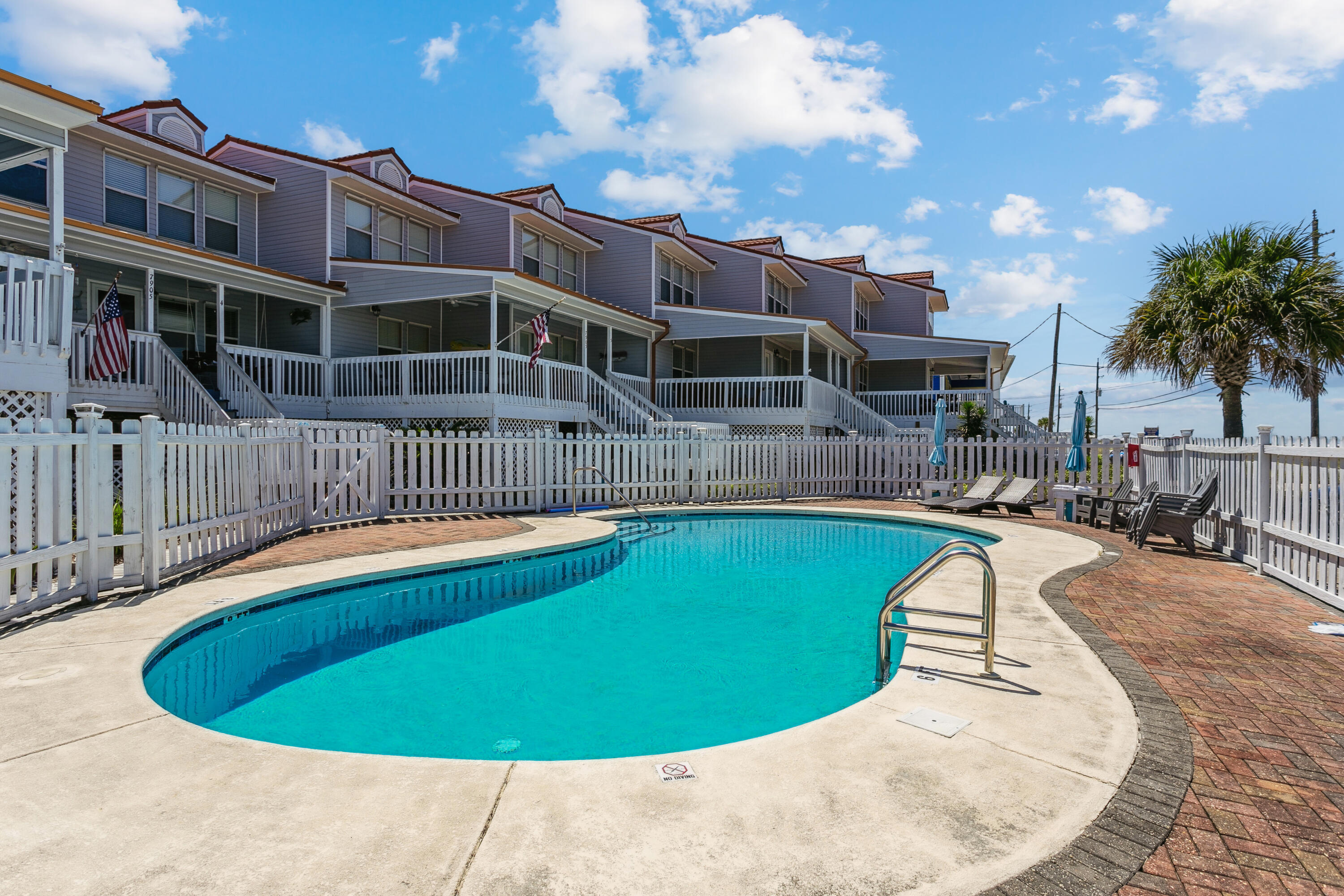 7905 White Sands Boulevard, Unit 2 Navarre, FL 32566 - Photo 41 of 51 a view of a swimming pool with a patio