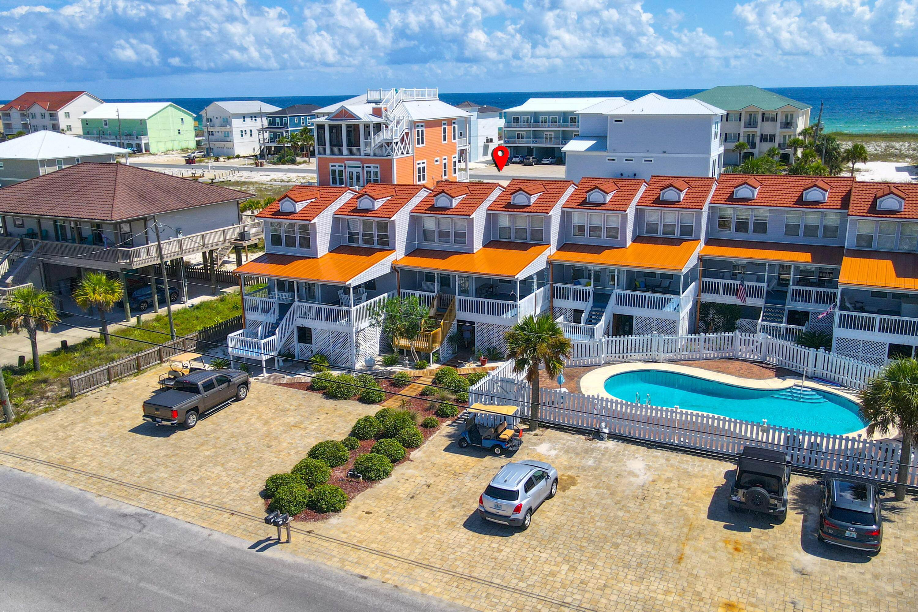 7905 White Sands Boulevard, Unit 2 Navarre, FL 32566 - Photo 8 of 51 a view of a chairs and table in a backyard