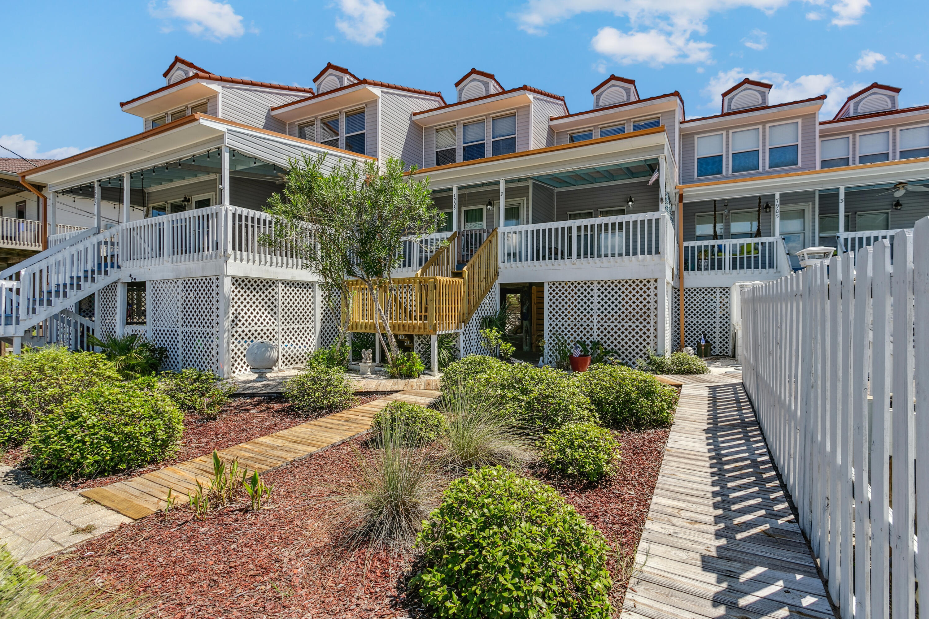 7905 White Sands Boulevard, Unit 2 Navarre, FL 32566 - Photo 9 of 51 a front view of a multi story residential apartment building