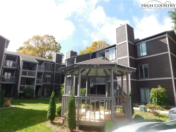 a view of a brick house with a yard next to a road