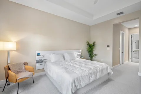 a bedroom with a bed and a lamp