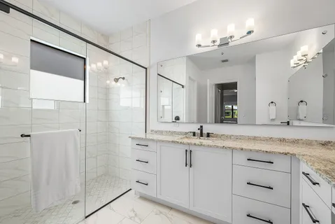 a bathroom with a granite countertop sink mirror and double