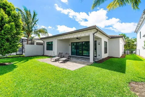 a view of a patio with chairs and plants