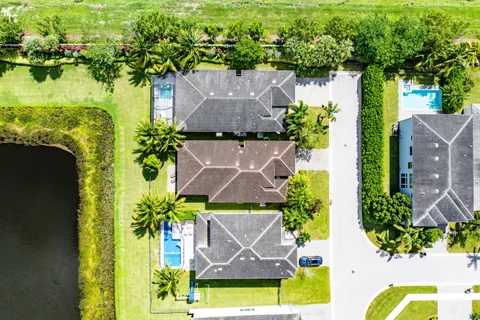 an aerial view of house with yard and swimming pool