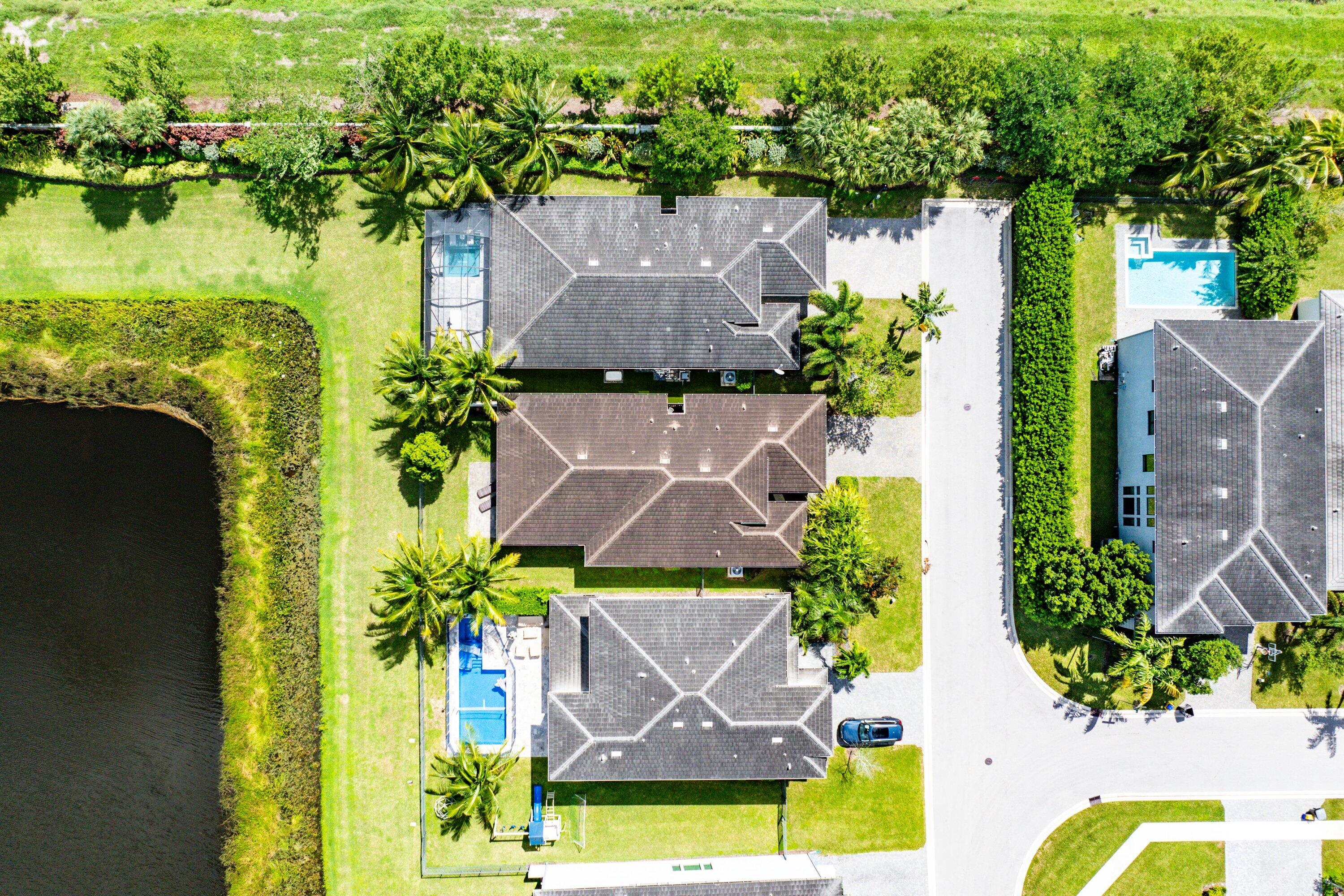 17390 Pagoda Palms Drive Boca Raton, FL 33496 - Photo 32 of 53 an aerial view of house with yard and swimming pool