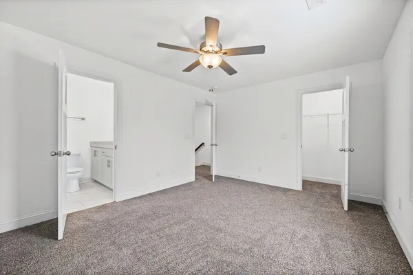 a bathroom with a toilet sink vanity and mirror