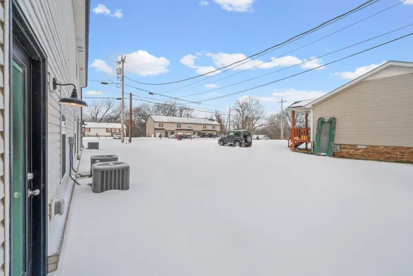 a view of a house with a snow in the yard
