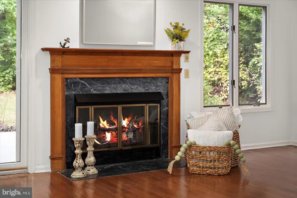 a living room with fireplace furniture and a window