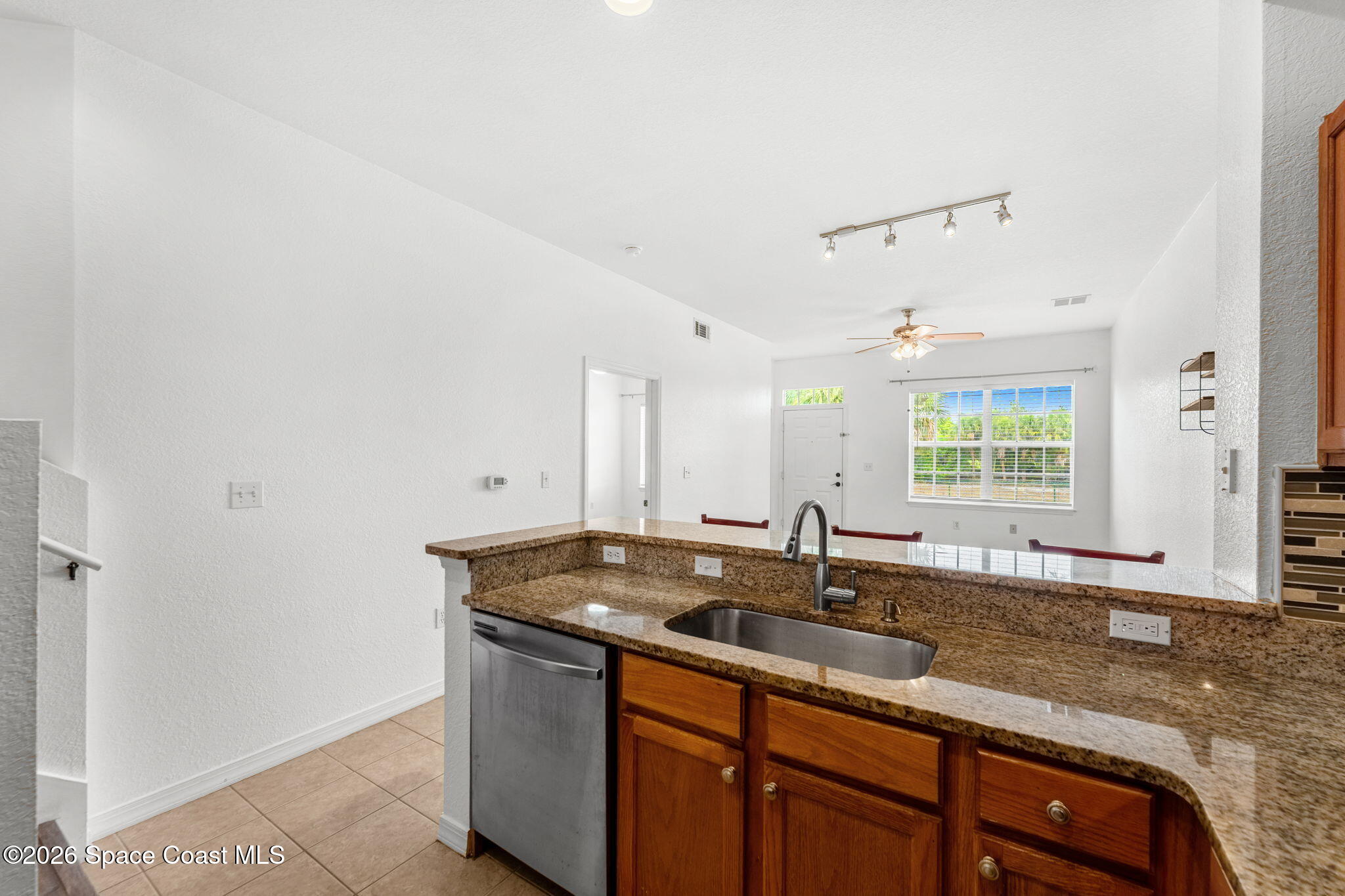 110 Turpial Way, Unit 106 Melbourne, FL 32901 - Photo 18 of 50 a kitchen with granite countertop a sink and a window