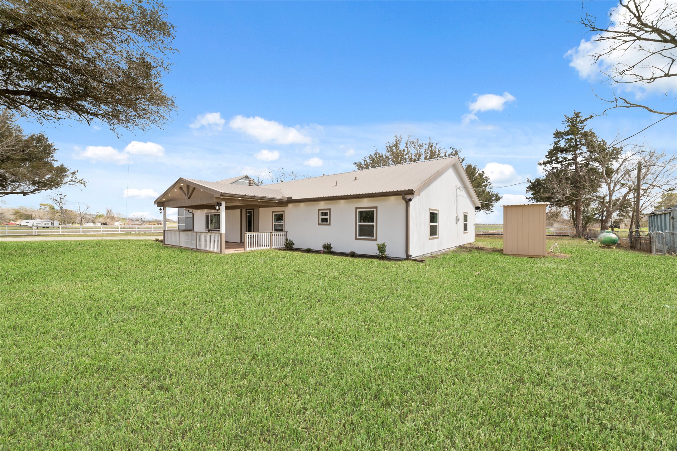 13431 Vrlla Road Guy, TX 77444 - Photo 26 of 32 a view of a white house with a big yard and large trees