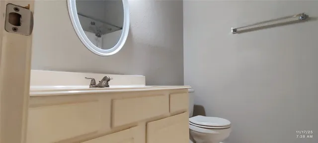 a bathroom with a toilet a sink and a mirror