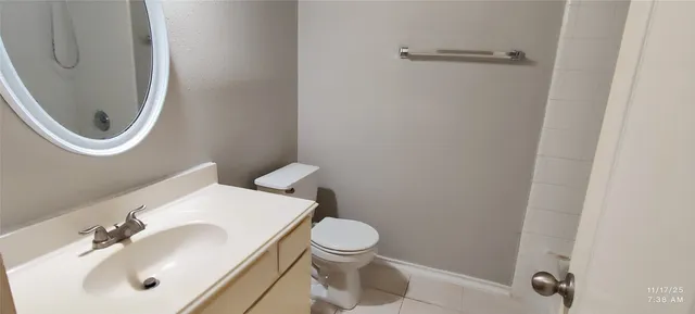 a bathroom with a toilet a sink and a mirror