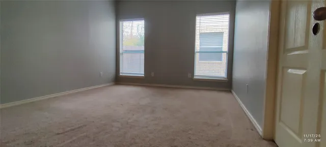 an empty room with windows and closet