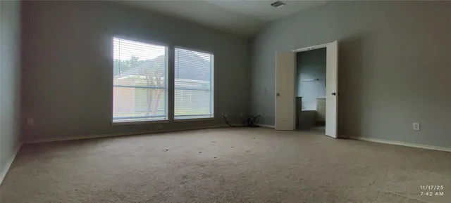 an empty room with windows and closet