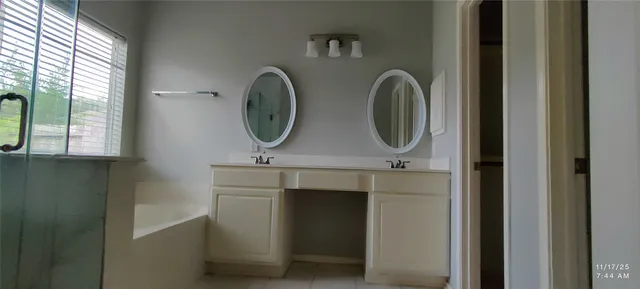 a bathroom with mirror and window