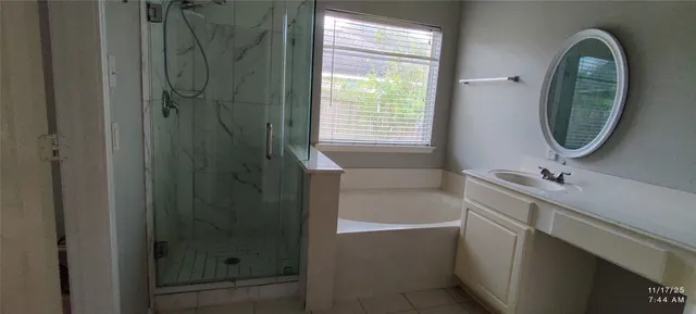 a bathroom with a tub sink and mirror