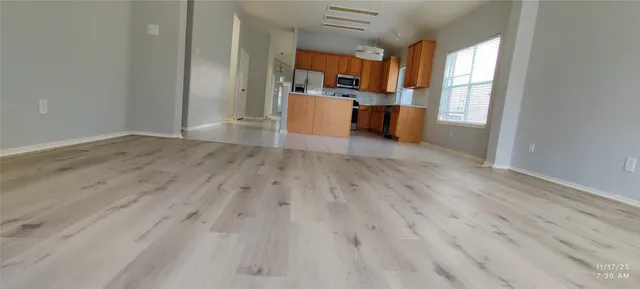 a view of living room and kitchen with wooden floor