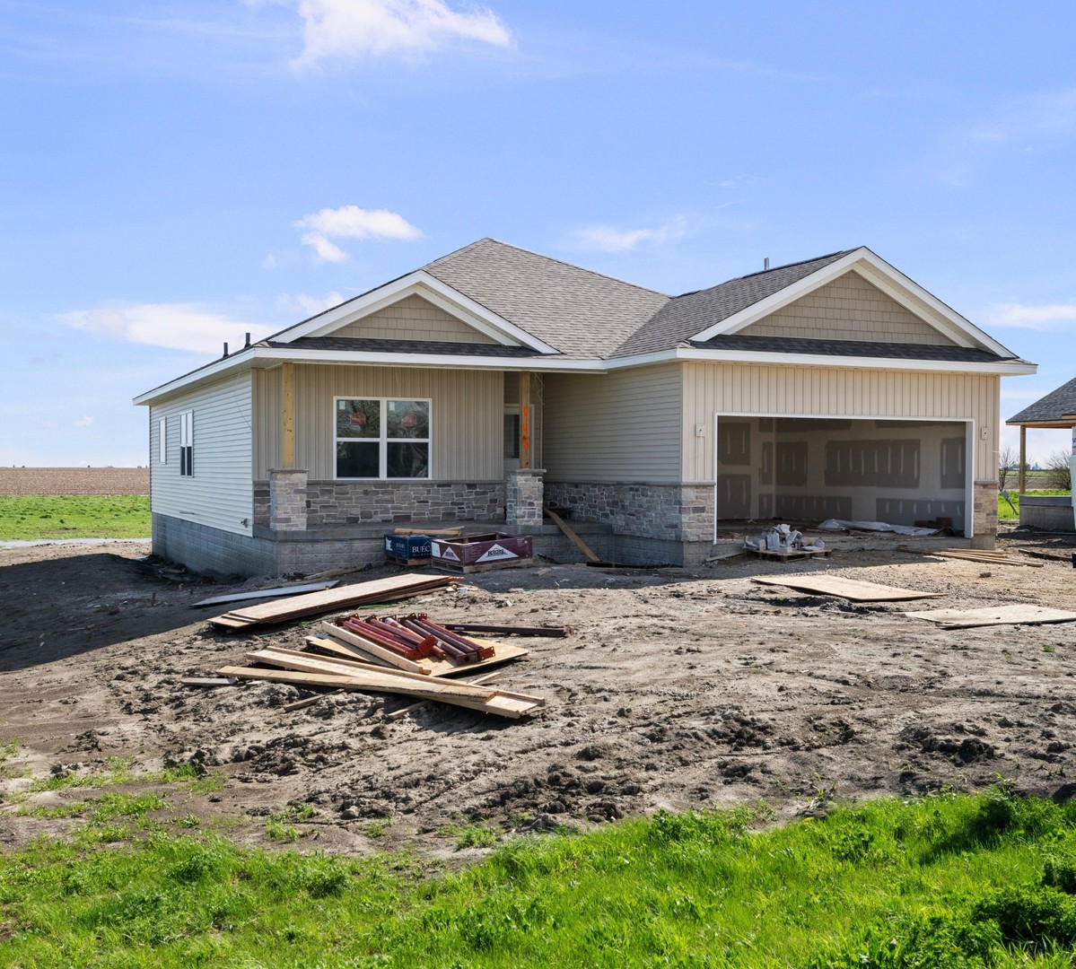445 Rhonda Road New Liberty, IA 52765 - Photo 3 of 6 a front view of a house with yard fire pit and outdoor seating