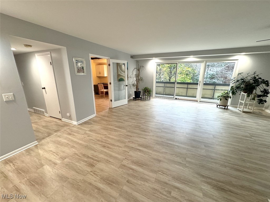 Unfurnished living room featuring light wood-type flooring