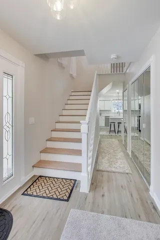 a view of an entryway with wooden floor