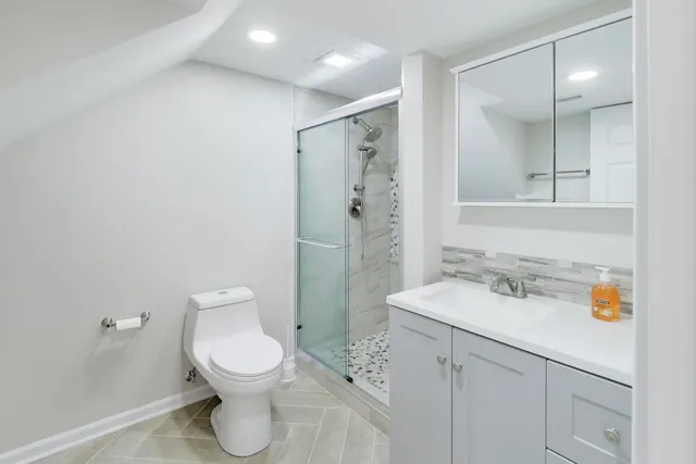 a bathroom with a toilet sink and shower