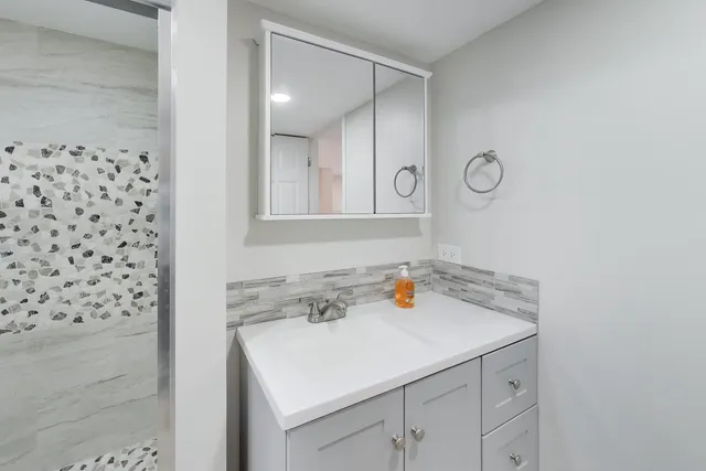 a bathroom with a sink and a mirror