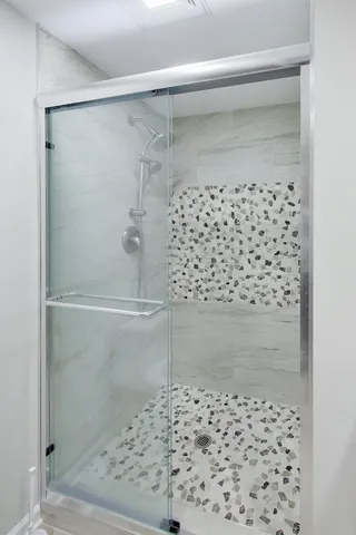 a bathroom with a shower and a sink