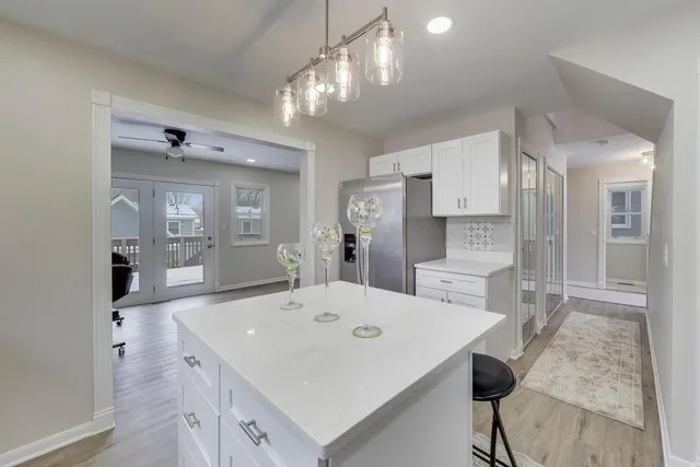 a large kitchen with a table and chairs