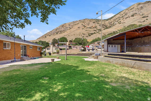 120 North 1230 E Street Springville, UT 84663 - Photo 35 of 60 Expansive lawn area with a concrete patio directly accessible from the brick-sided residence
