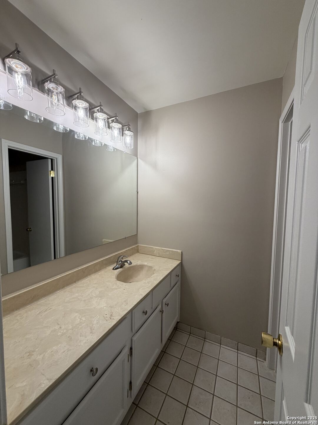 5955 Spring Crossing San Antonio, TX 78247 - Photo 14 of 17 a bathroom with a sink and a mirror
