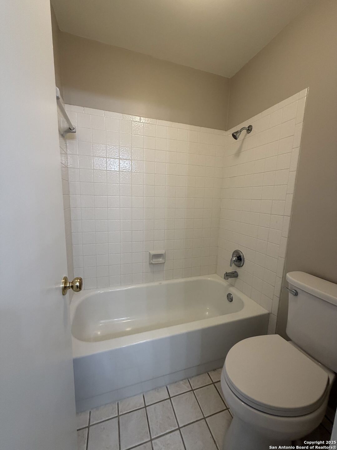 5955 Spring Crossing San Antonio, TX 78247 - Photo 15 of 17 a bath room with a toilet and a bath tub