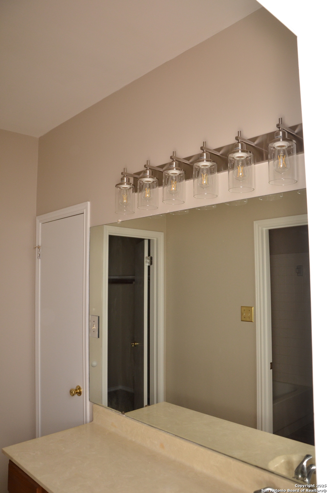 5955 Spring Crossing San Antonio, TX 78247 - Photo 8 of 17 a bathroom with a sink and a mirror