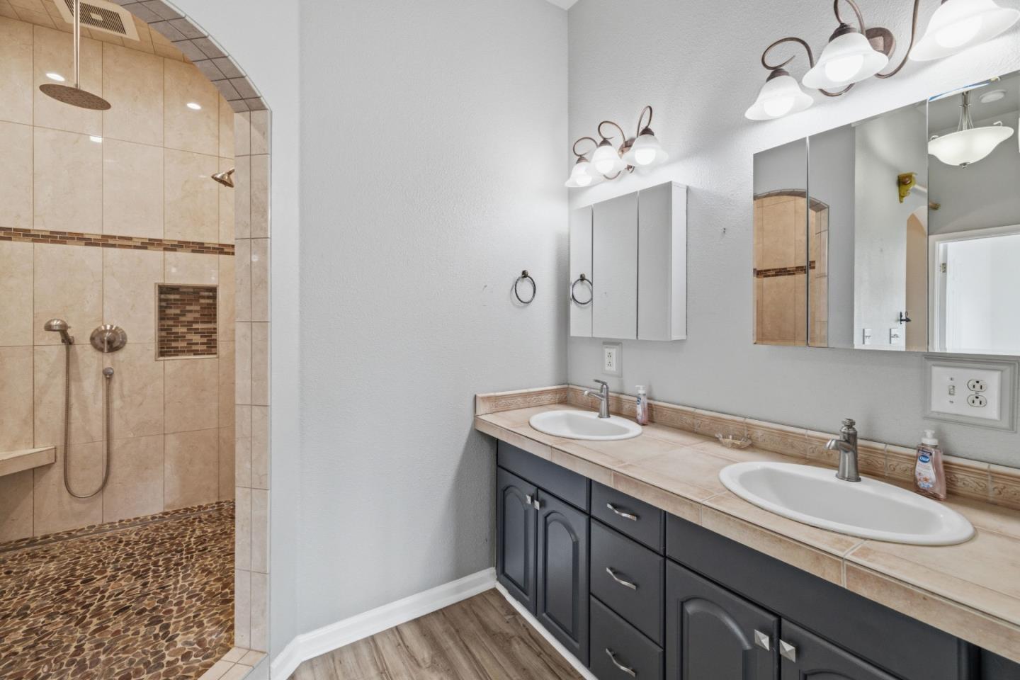 19269 Mallory Canyon Road, Unit D Salinas, CA 93907 - Photo 29 of 77 a bathroom with a double vanity sink mirror and shower