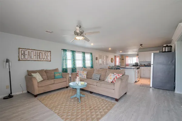 a living room with furniture and a chandelier