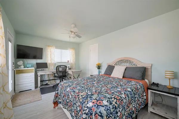 a bedroom with a large bed and flat tv