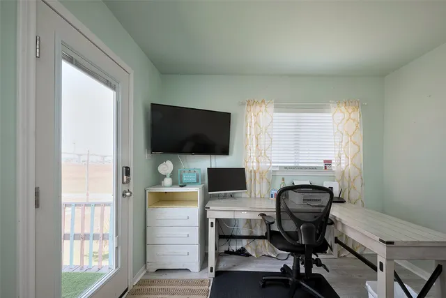 a view of a workspace with furniture and a window